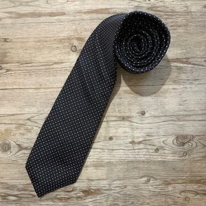 Hardy Amies tie.  Dark navy (almost black) with white polka dots.